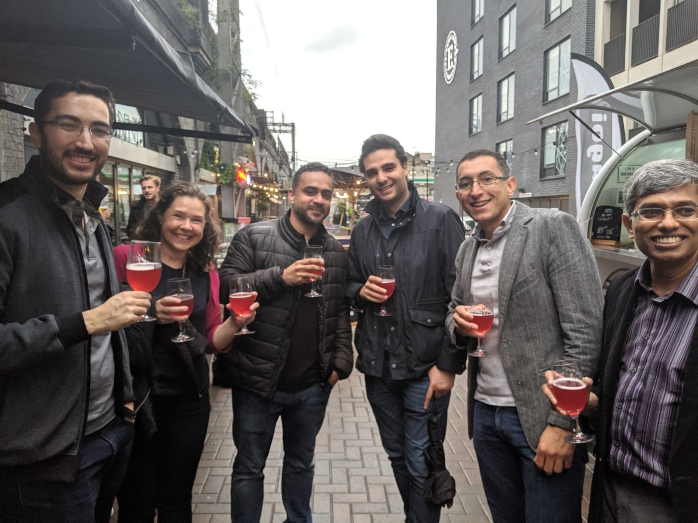 Friends toasting fruit beers on a Bermondsey street